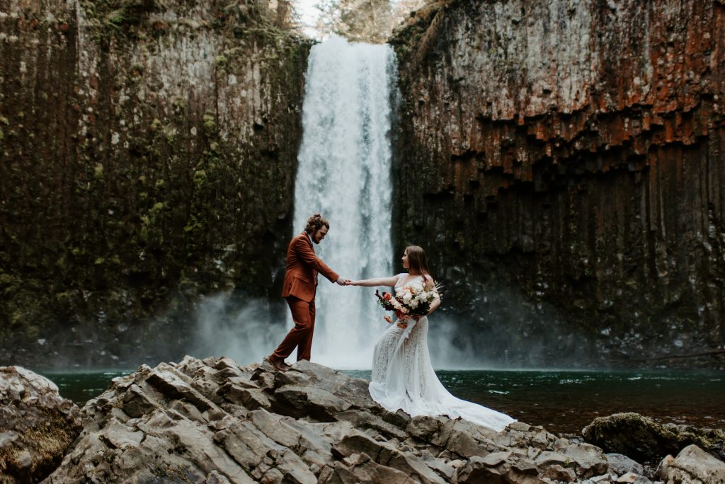 Adventurous Oregon waterfall elopement formal portraits on a rock