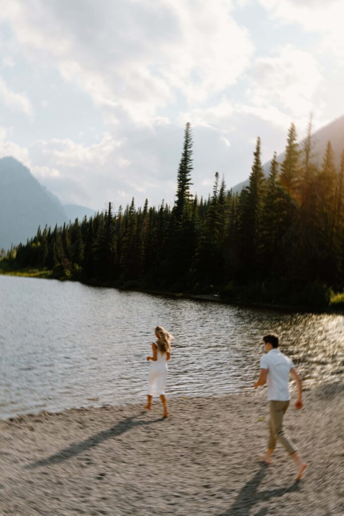 Blurry photo of a couple running into the water at Pray Lake in Glacier National Park, Montana