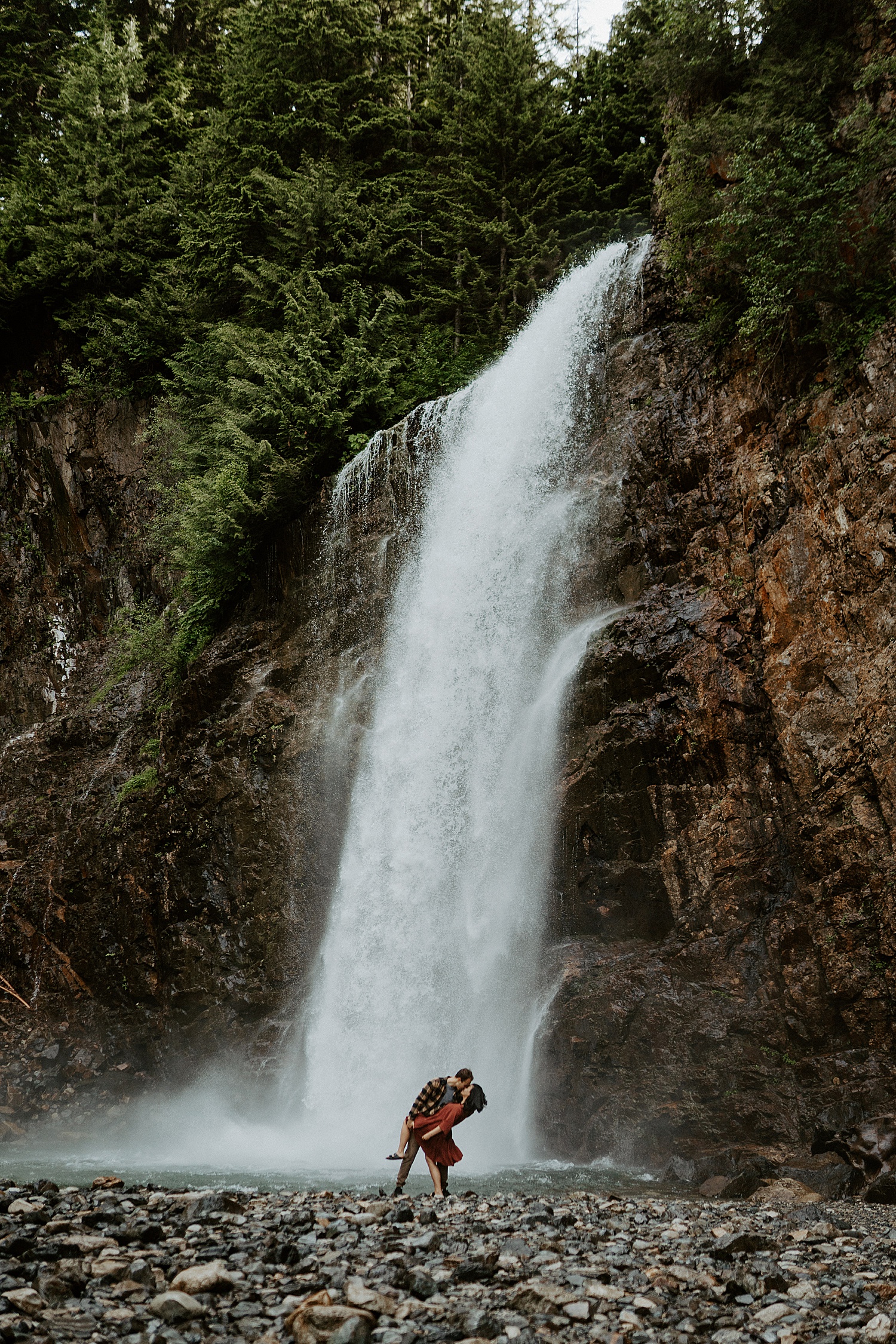 Couple kissing under a waterfall