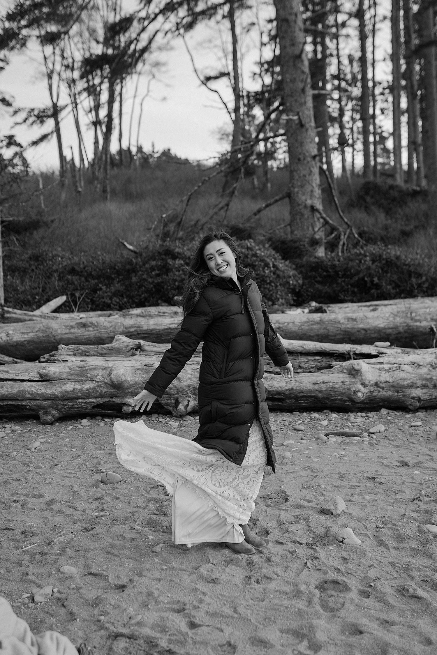 eloping bride in a puffy coat on the coast