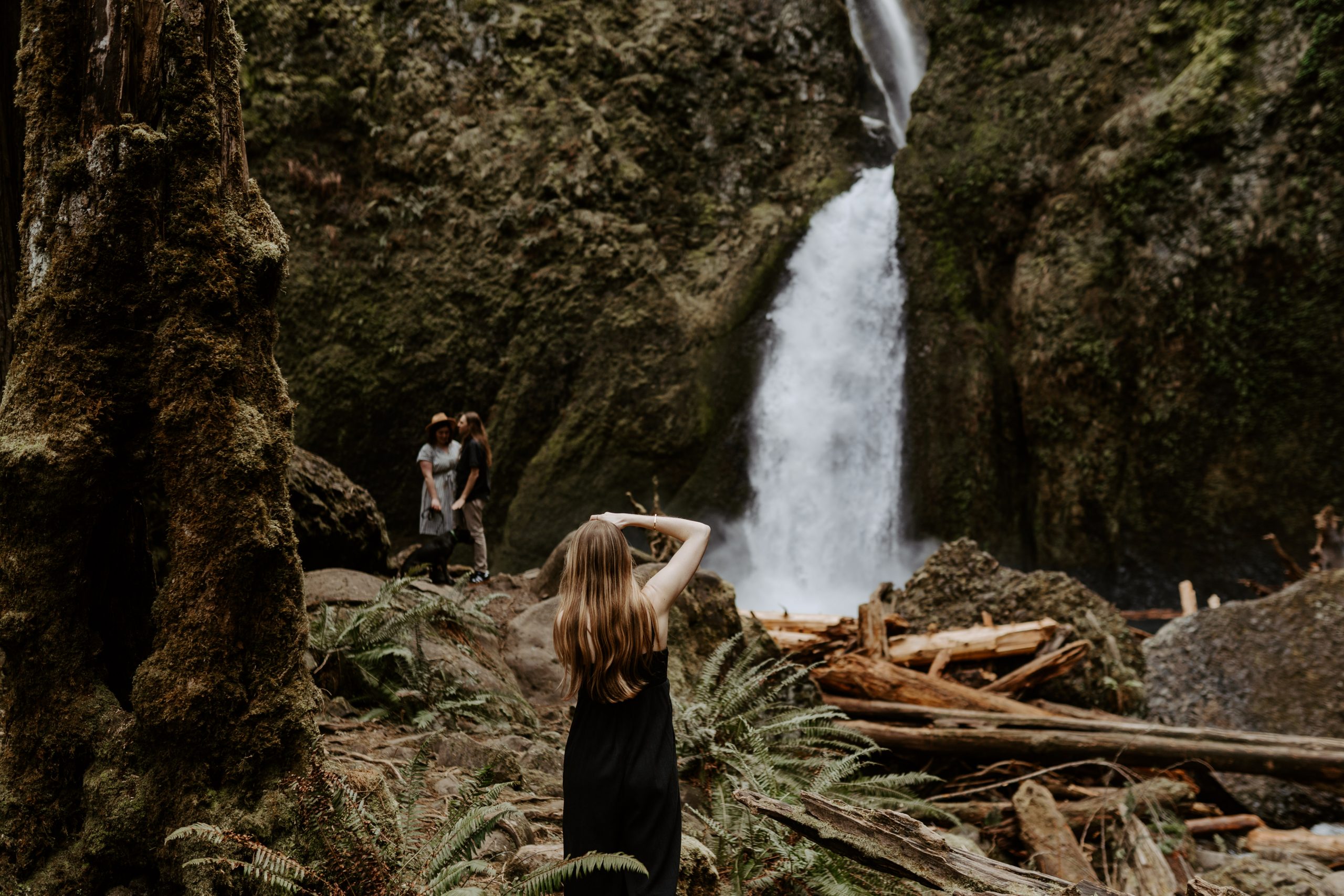 Hannah photographing a couple in front of a waterfall
