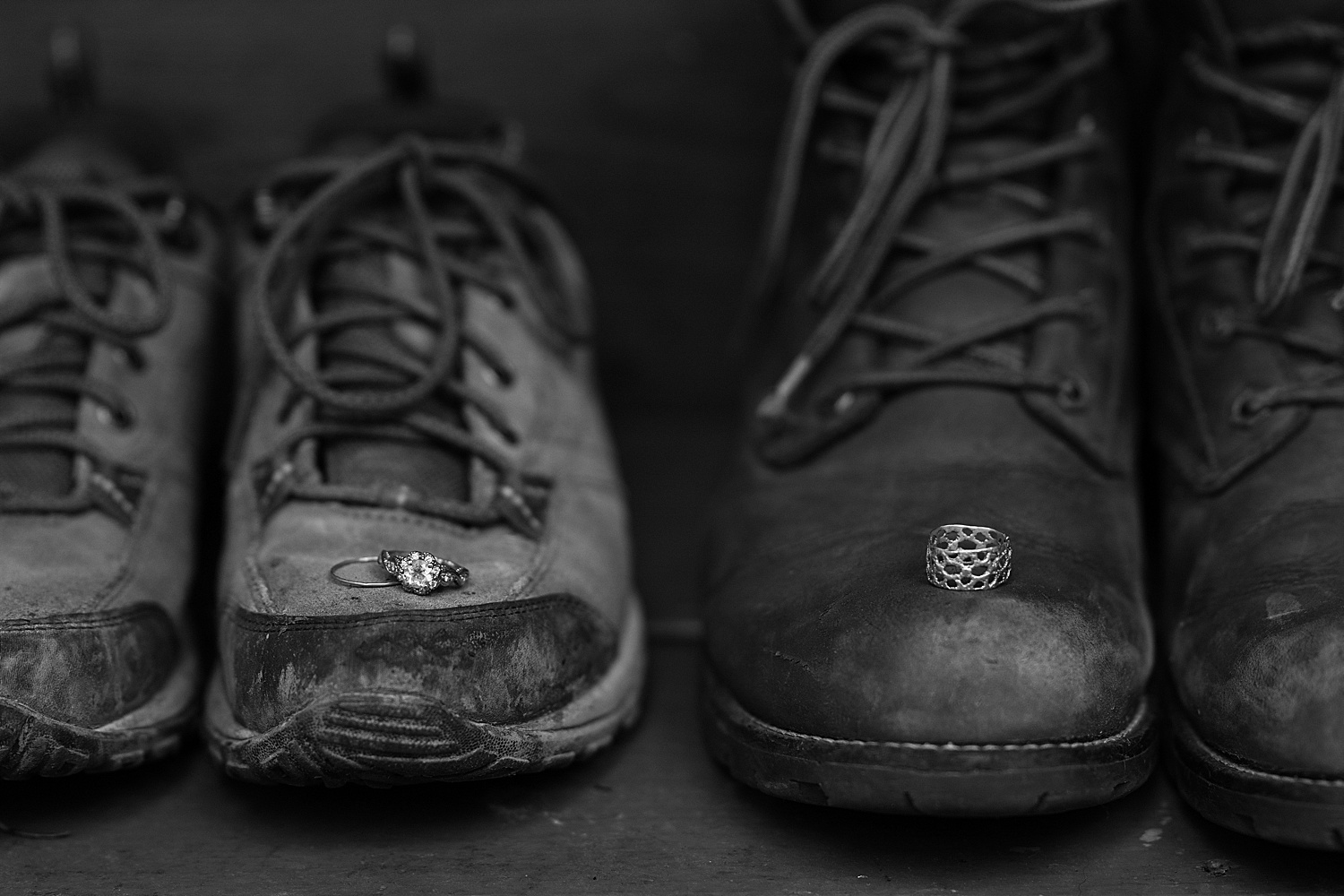 black and white photo of rings on hiking boots