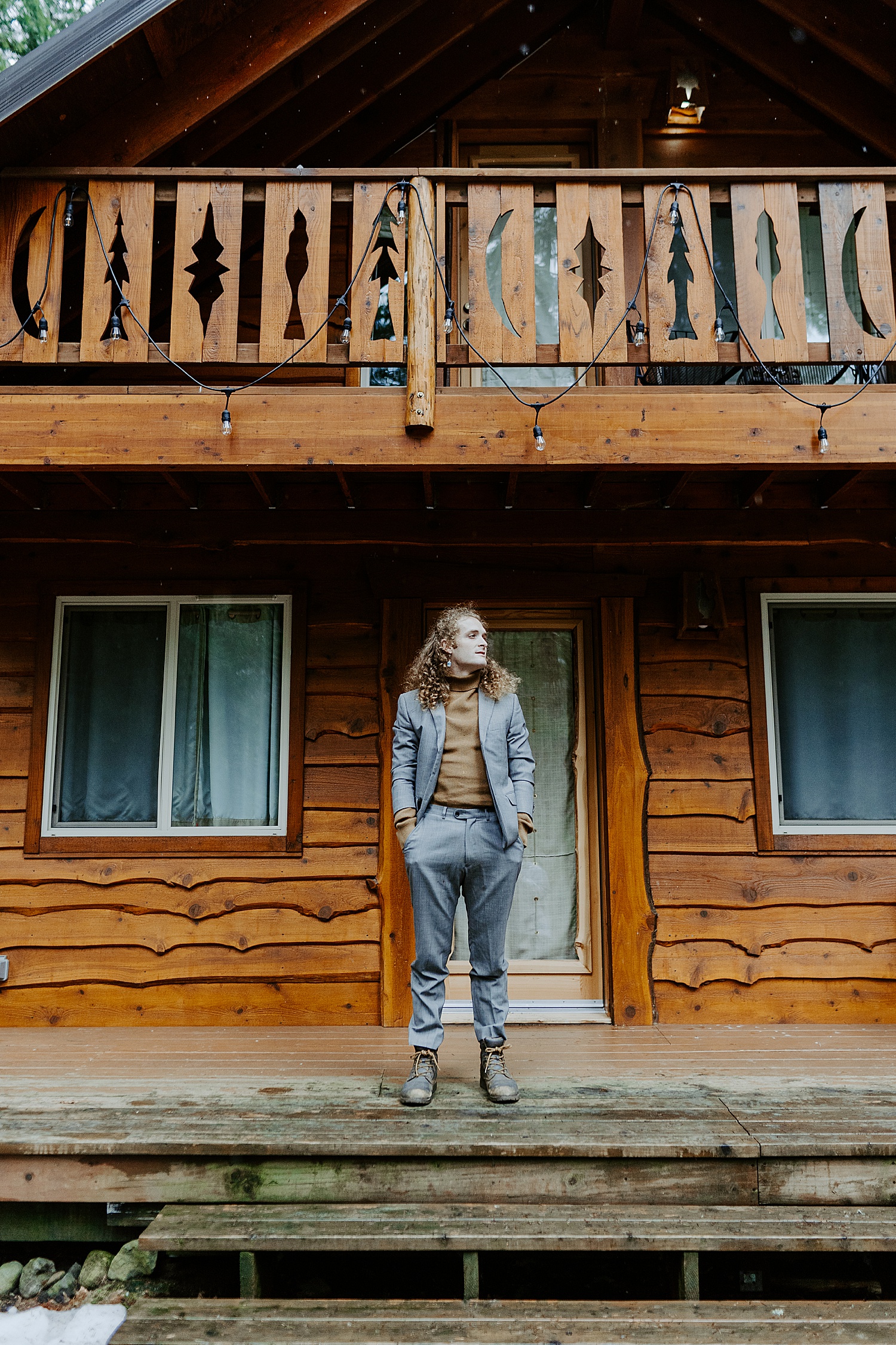 groom portrait in front of a cabin