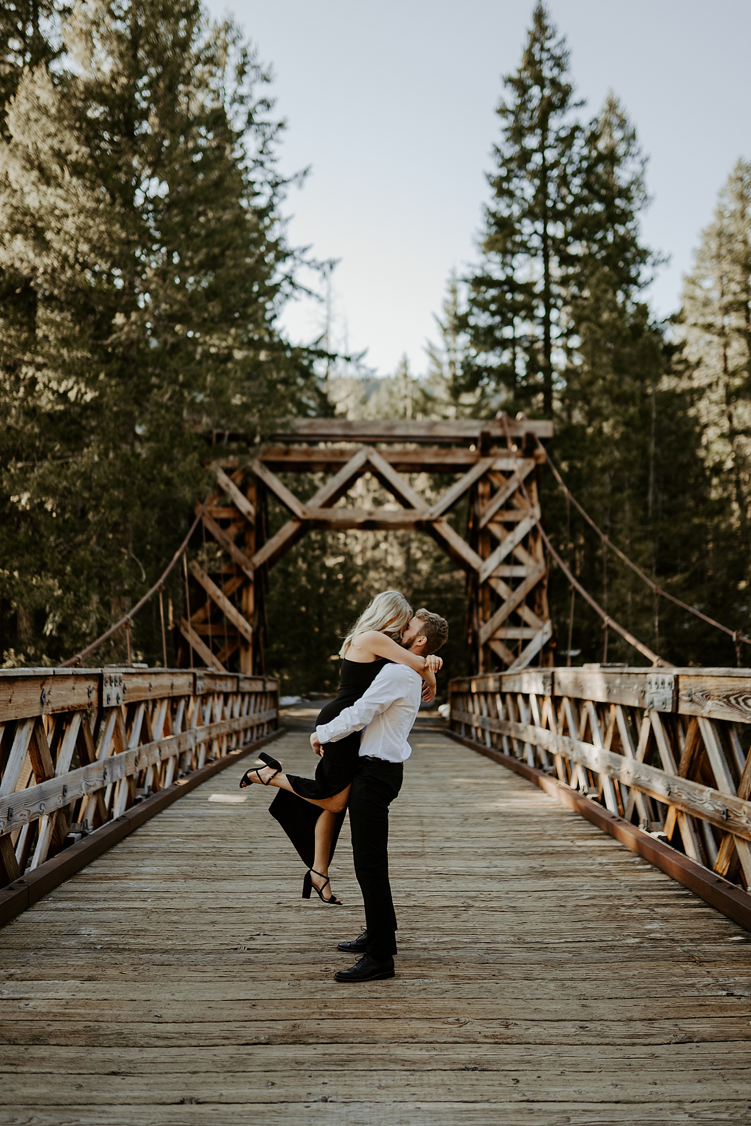 enagegd couple dancing on a bridge at Mount Rainier