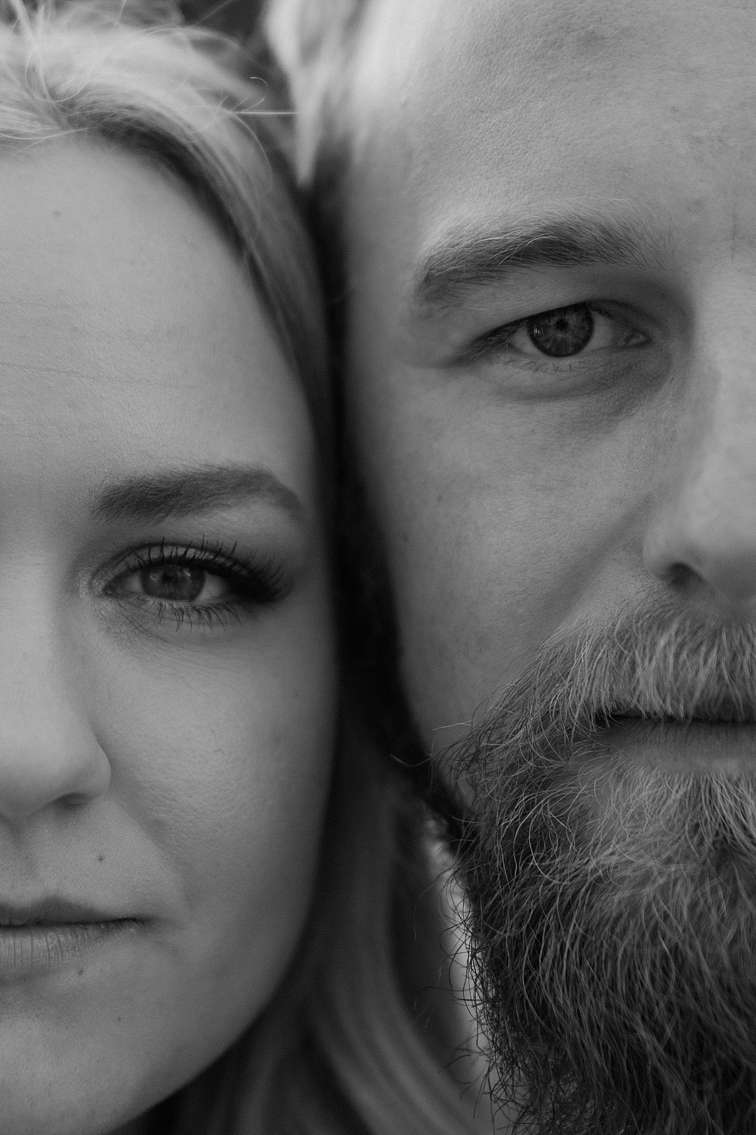 up close black and white image of a couples faces