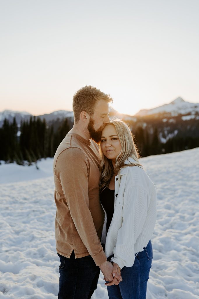 snowy winter engagement photos at sunset in the mountains