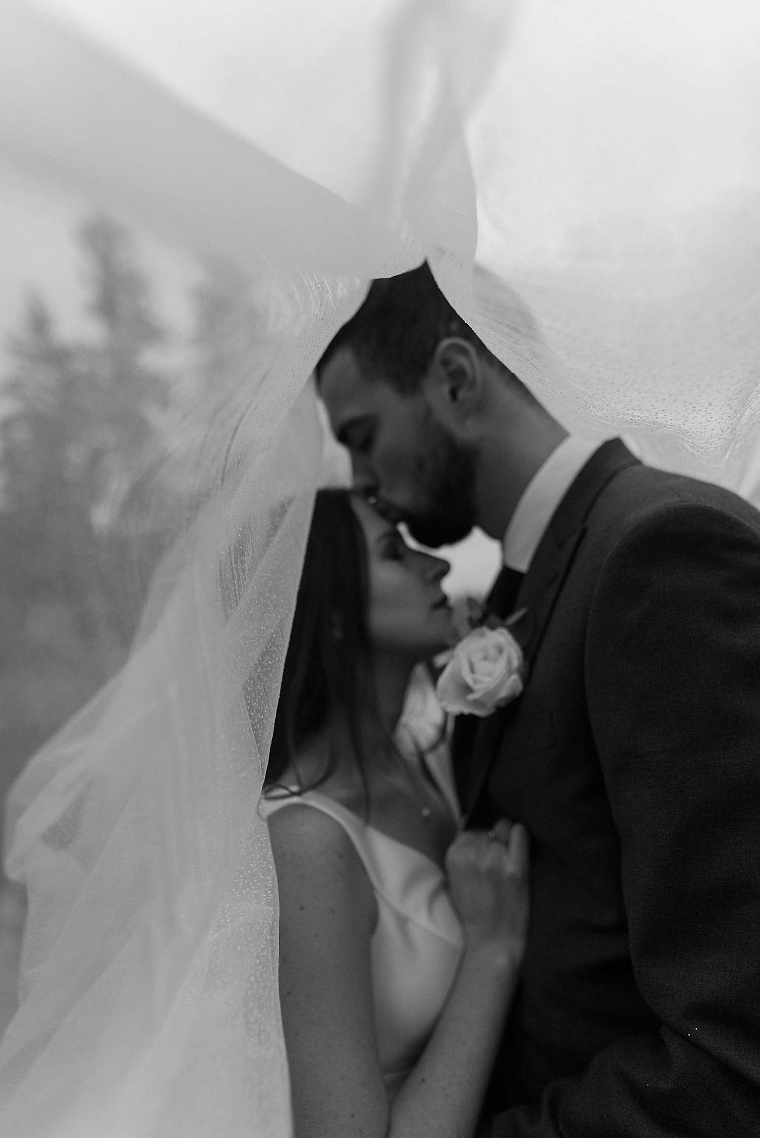 Black and white bride and groom portraits on a lake