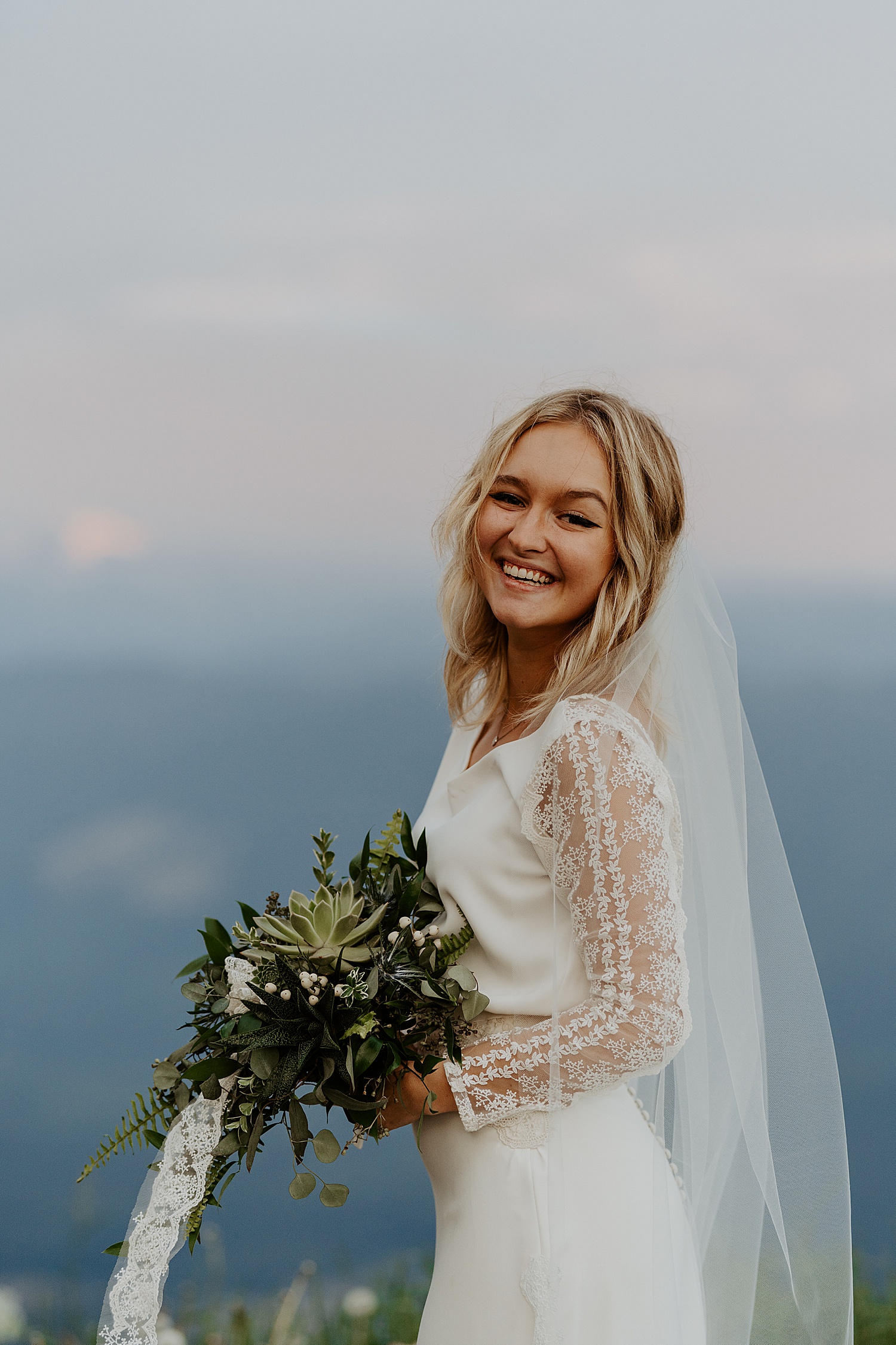 Sunrise portrait of a bride in a long sleeve dress