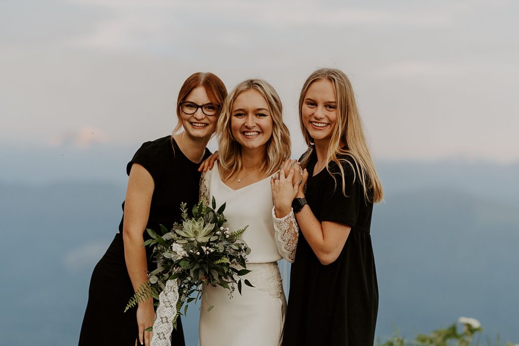 bride with her sisters at sunrise