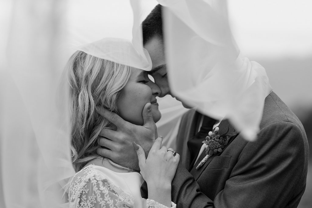 black and white under the veil shot of the bride and groom