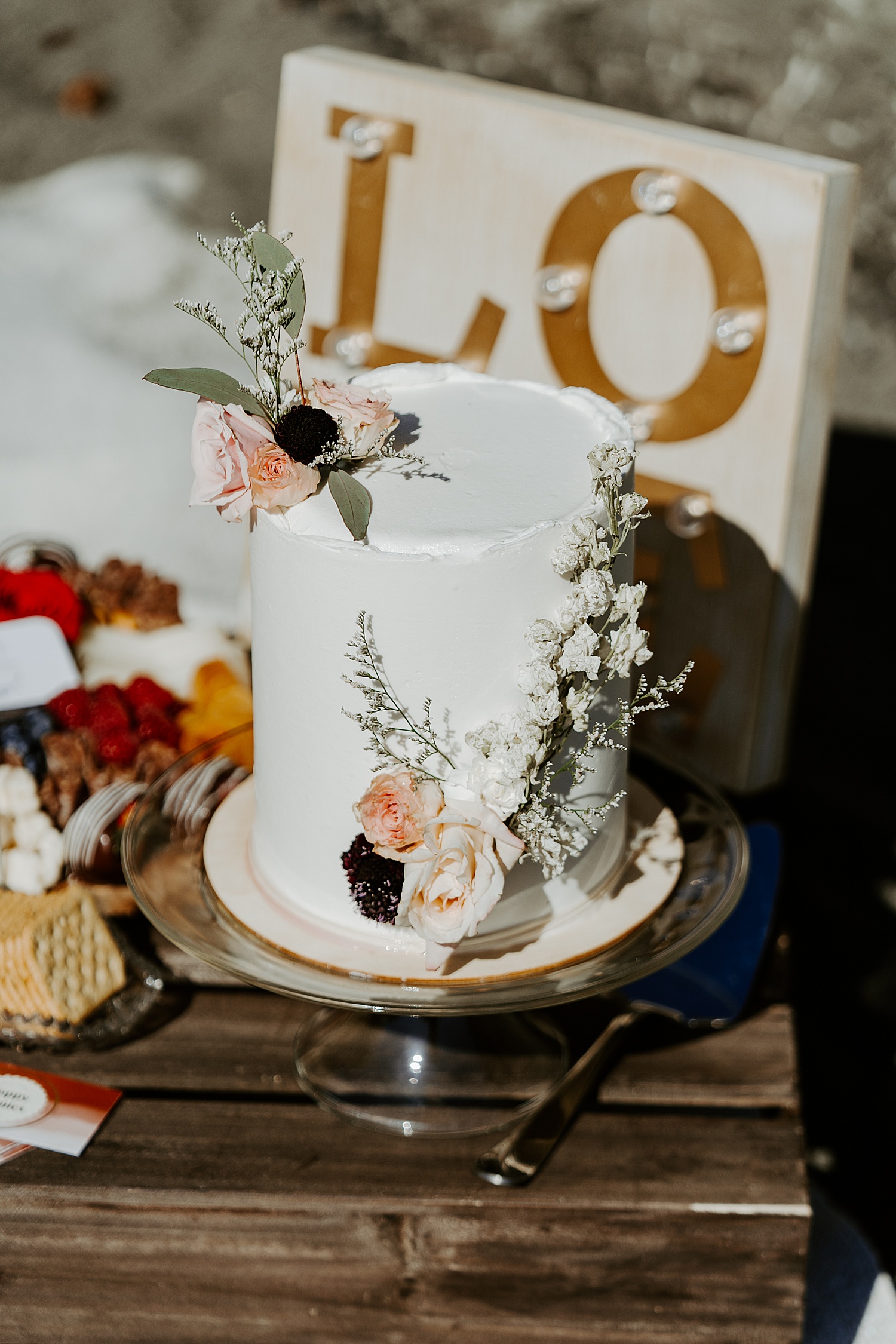 Simple white wedding cake with floral details