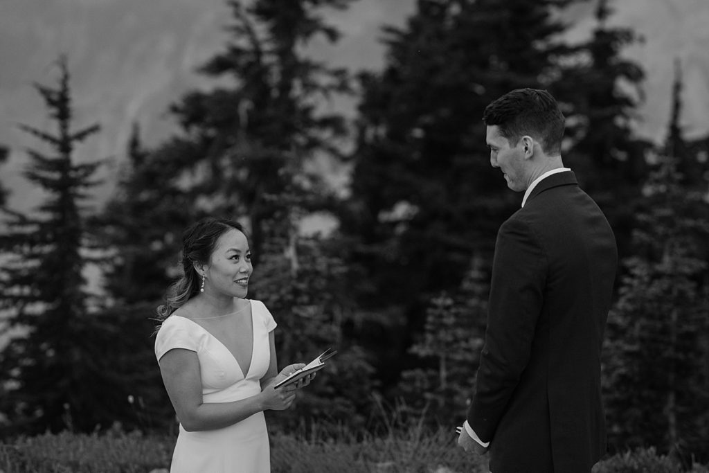 black and white photo of bride and groom exchanging vows