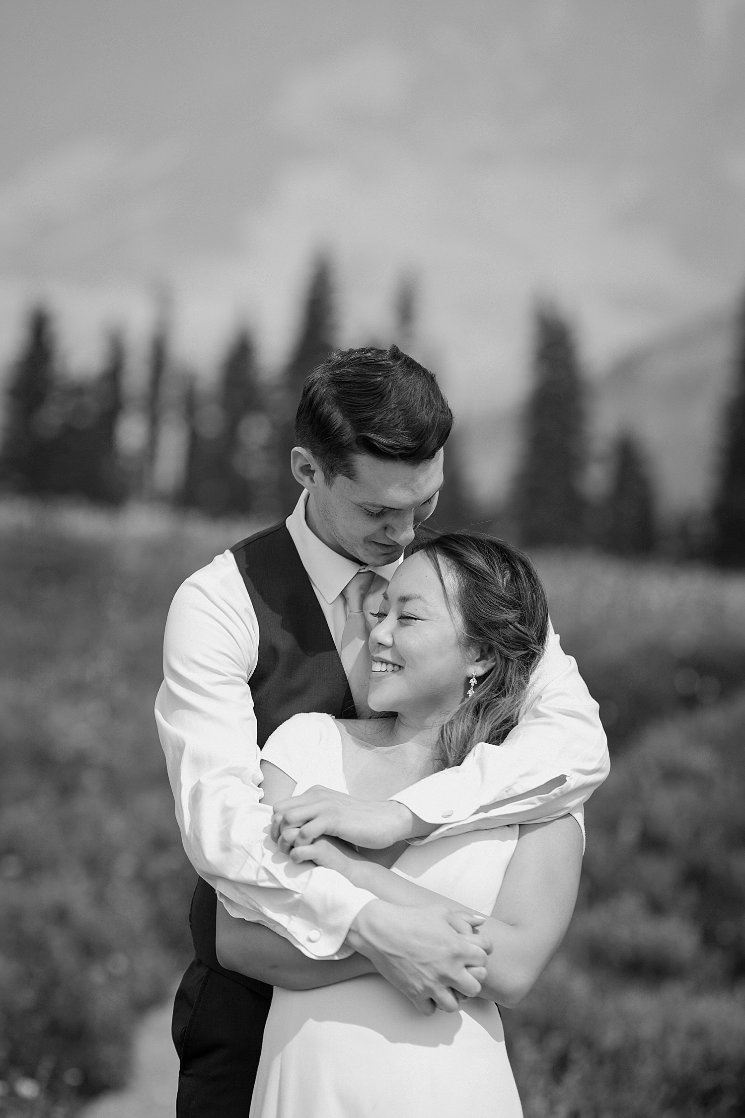 black and white portrait of bride and groom kissing at rainier