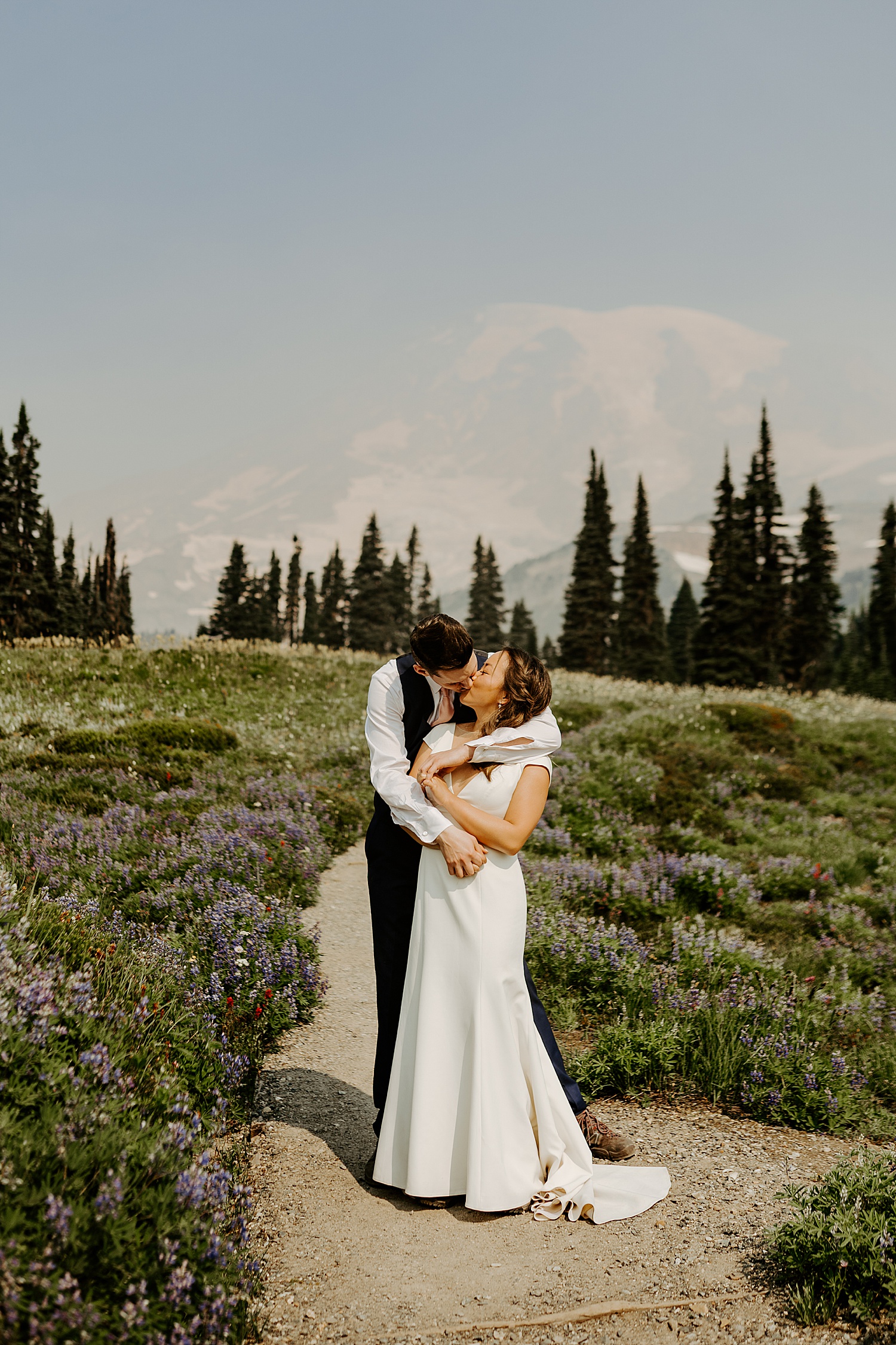 bride and groom elopement portraits in a meadow at mount rainier