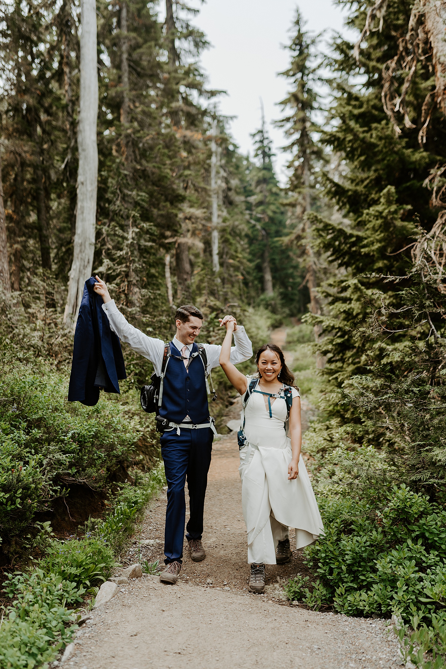 bride and groom celebrating after their hike
