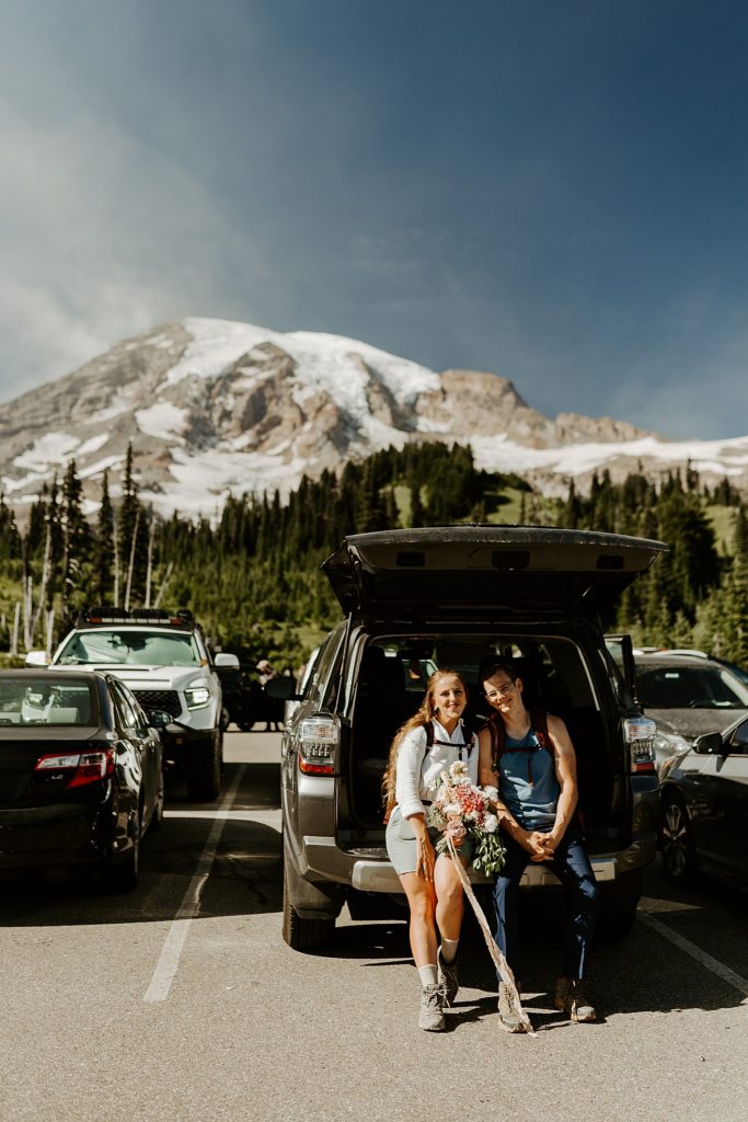 bride and groom in the parking lot at mount rainier