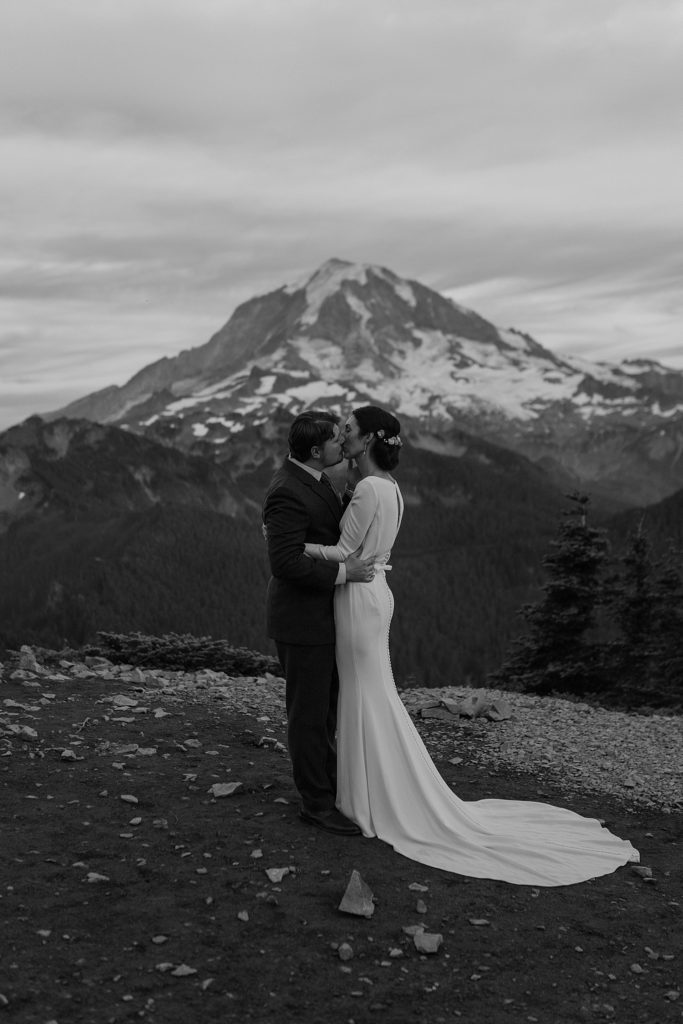 black and white photo of bride and groom in front of mount rainier
