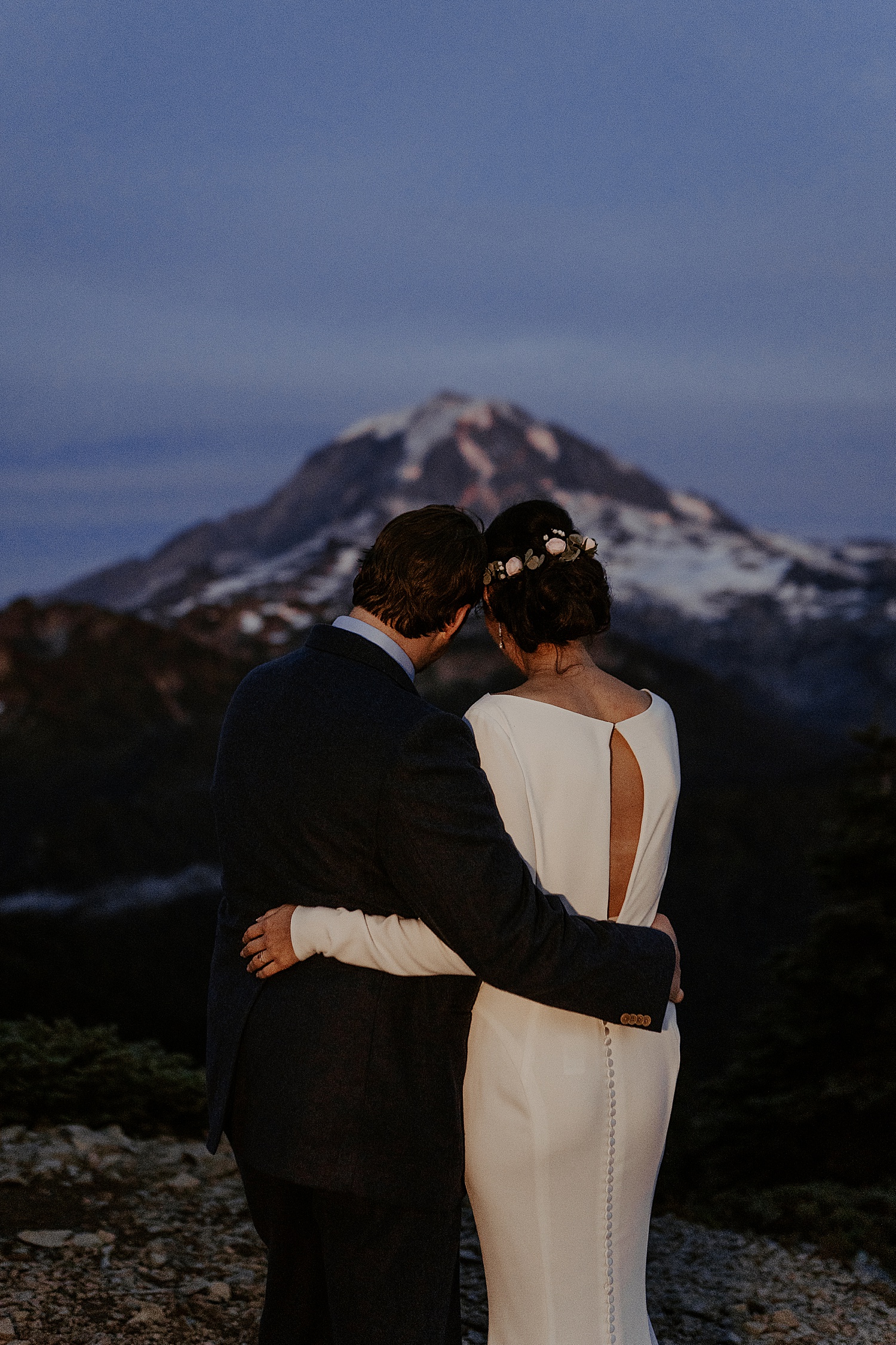 bride and groom portrait at night in front of mount rainier