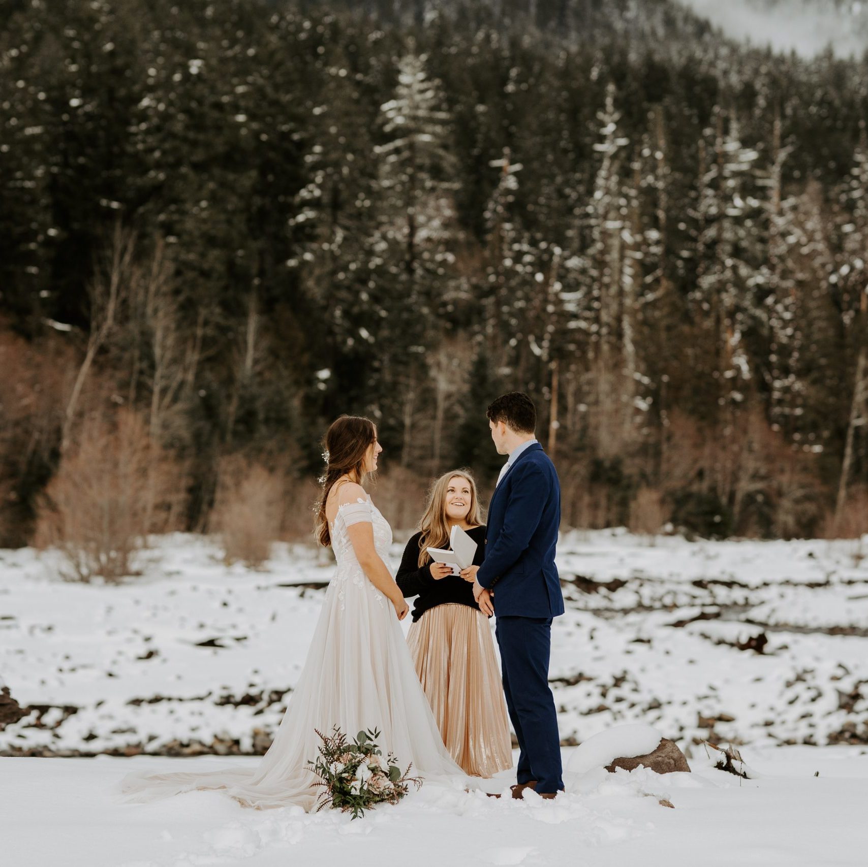 couple eloping in the winter by a river