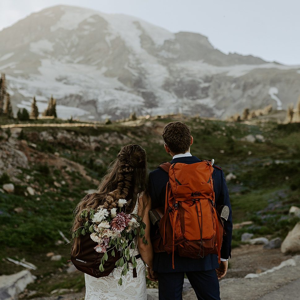 bride and groom hiking at mount rainier