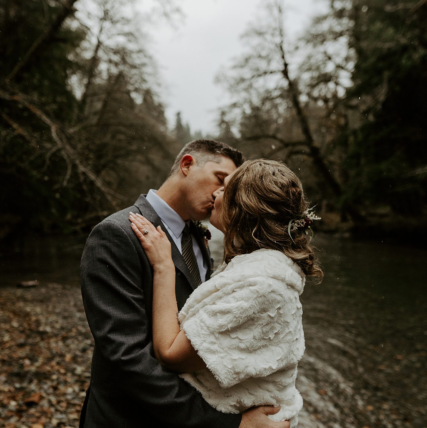 Mount Rainier riverside elopement with a couple kissing