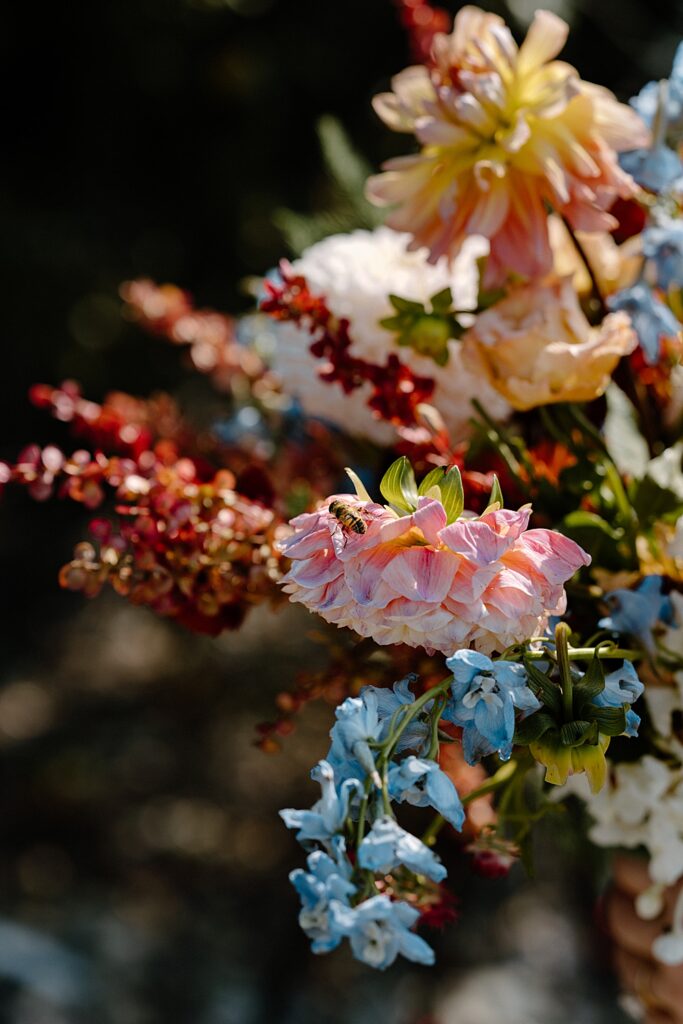 Image of a honeybee on a pink flower in a bridal wedding bouquet. 