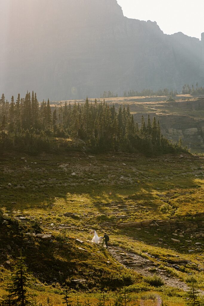Bride and groom hiking at Logan Pass in Montana. 