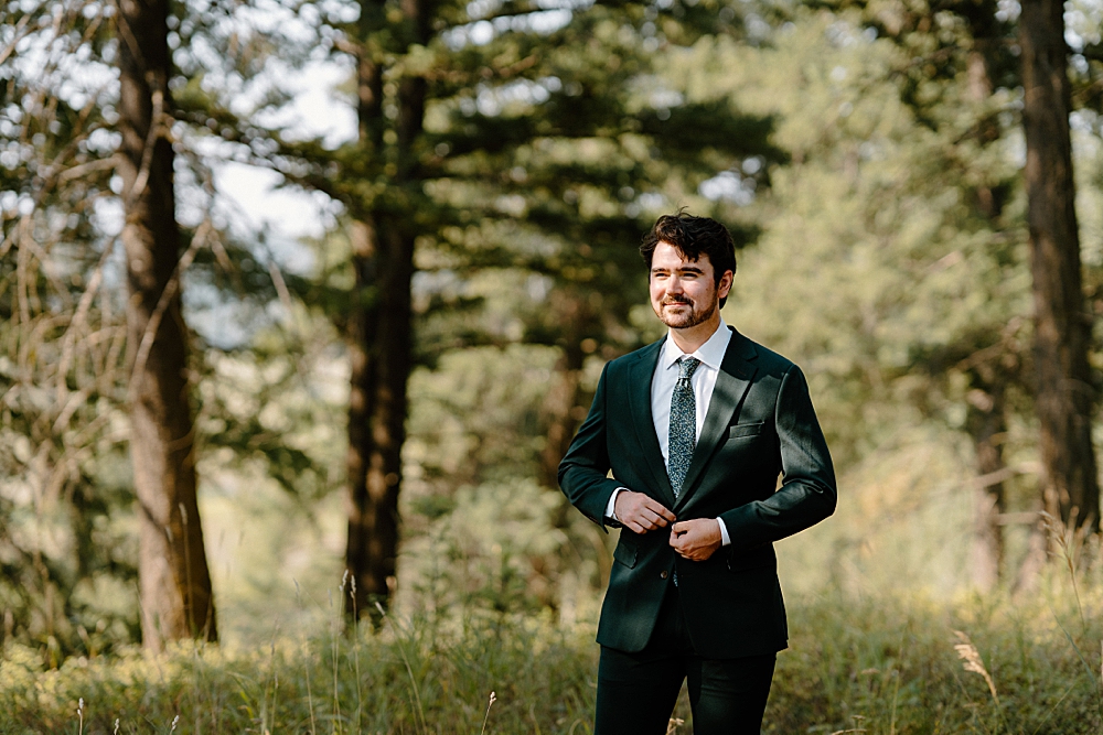 Groom in a green wedding suit with a green floral tie. 