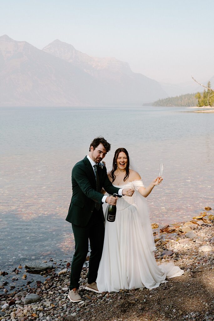 Bride and groom celebrating with champagne at 10-Mile Pullout after their Lake McDonald elopement ceremony. 