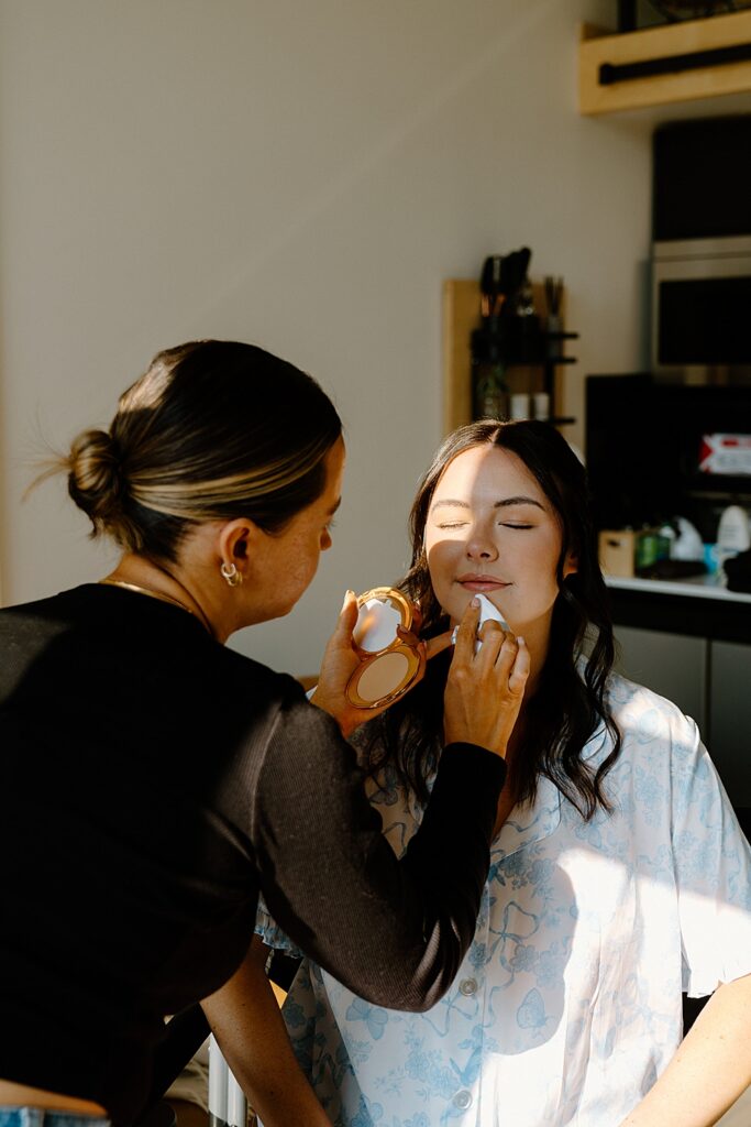 Bride getting her makeup done by Covet Beauty in Montana