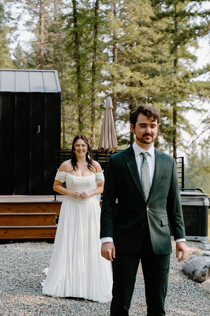 Bride and groom's first look outside tiny cabin near Glacier Park, Montana.