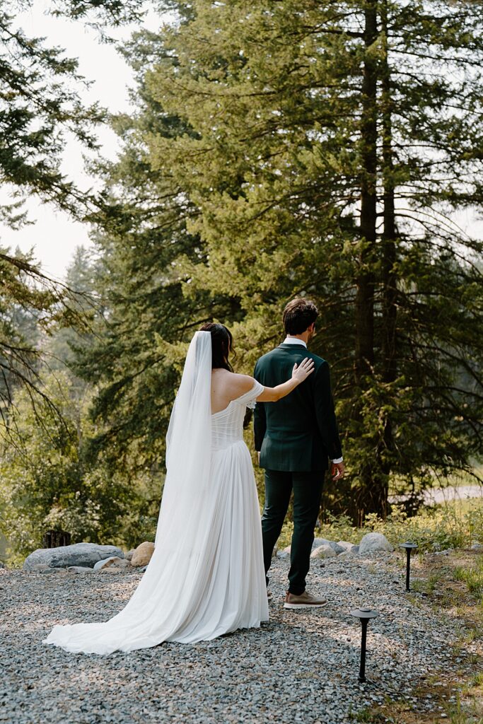 Bride and groom's first look outside tiny cabin near Glacier Park, Montana.