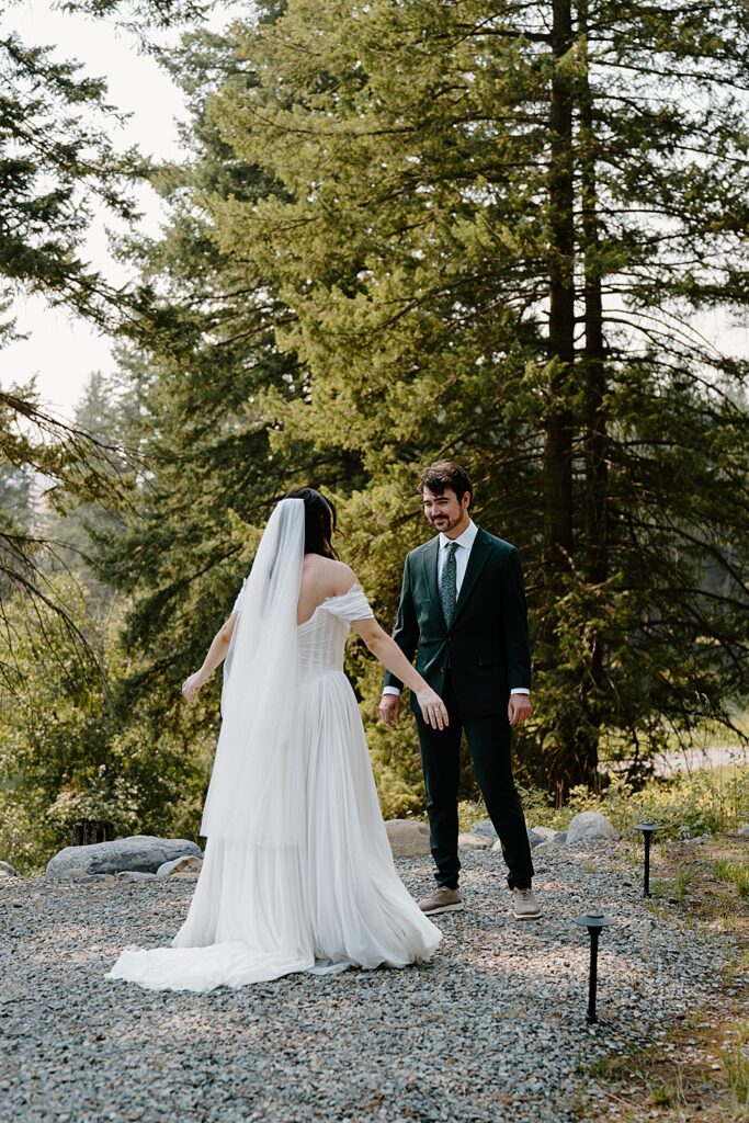 Bride and groom's first look outside tiny cabin near Glacier Park, Montana.