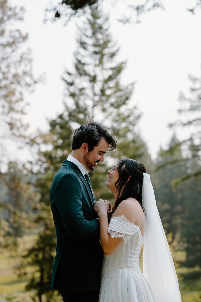 Bride and groom's first look outside tiny cabin near Glacier Park, Montana.