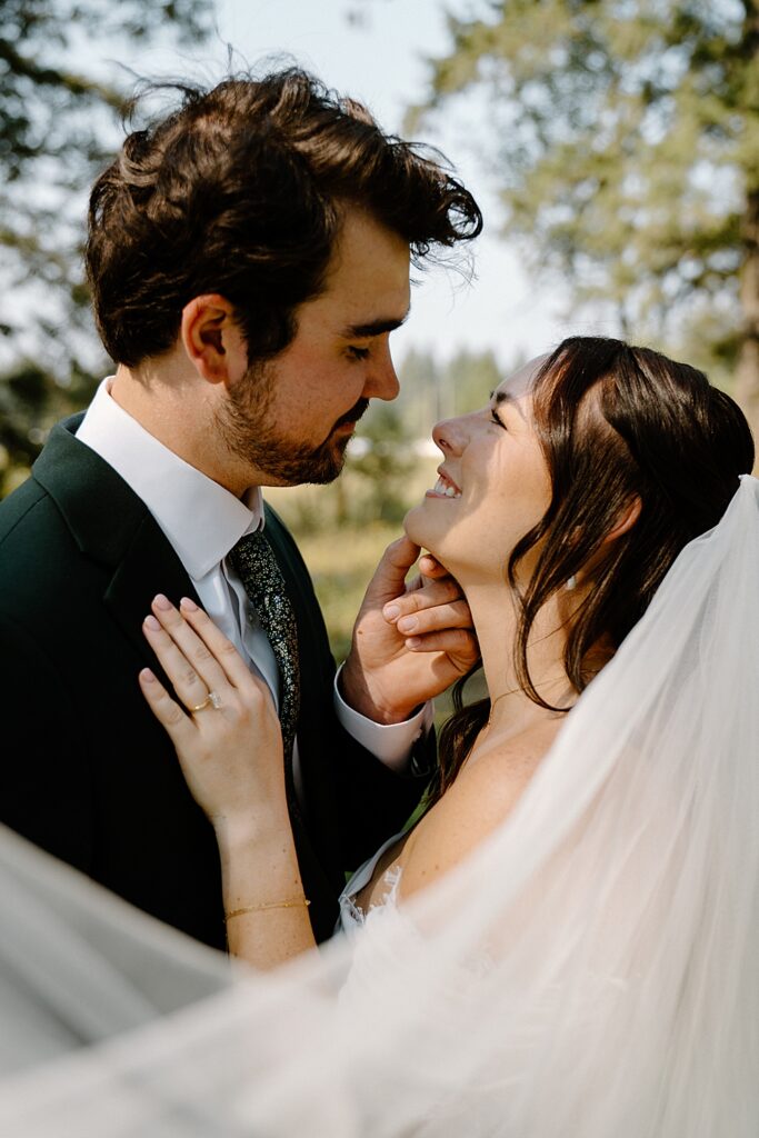 Elopement photo of bride and groom up close with wedding veil in the foreground