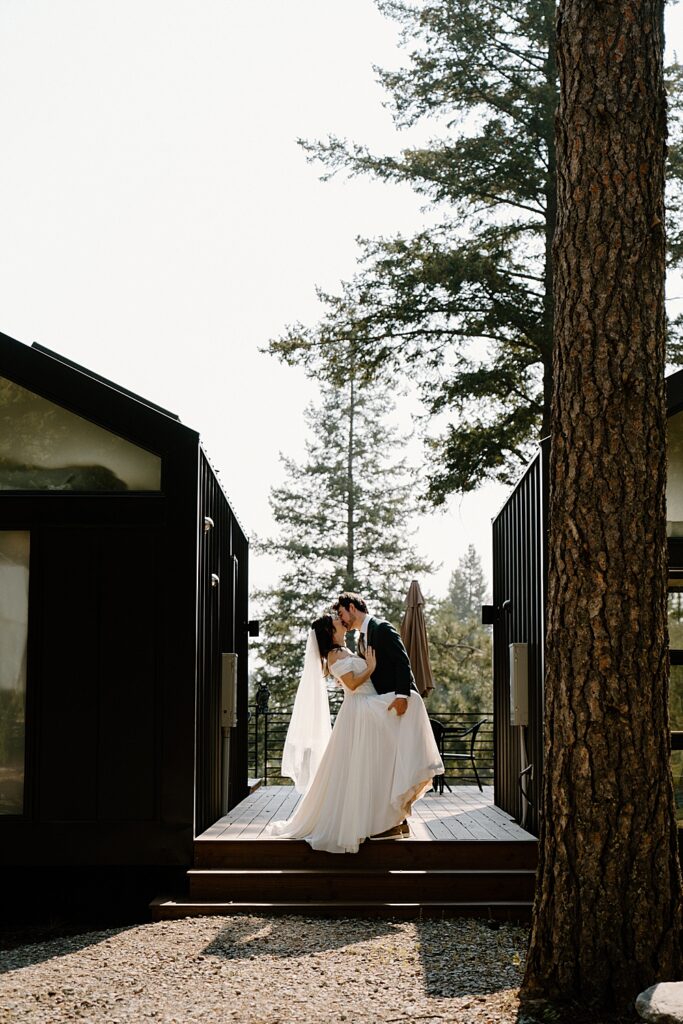 Bride and groom dip kissing at small Airbnb venue in Columbia Falls, Montana