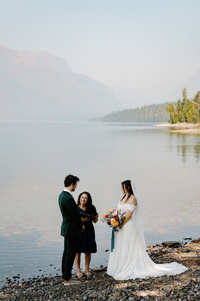 Elopement ceremony with an officiant at 10-mile pullout along the shore of Lake McDonald in Glacier Park