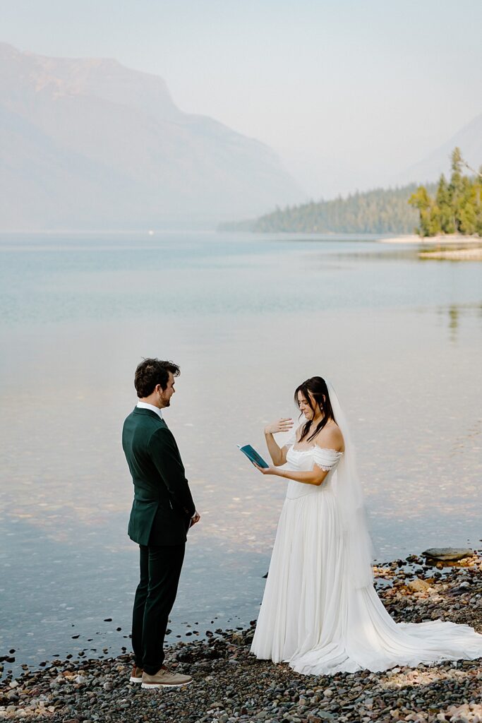 Bride and groom saying vows along Lake McDonald in Glacier National Park