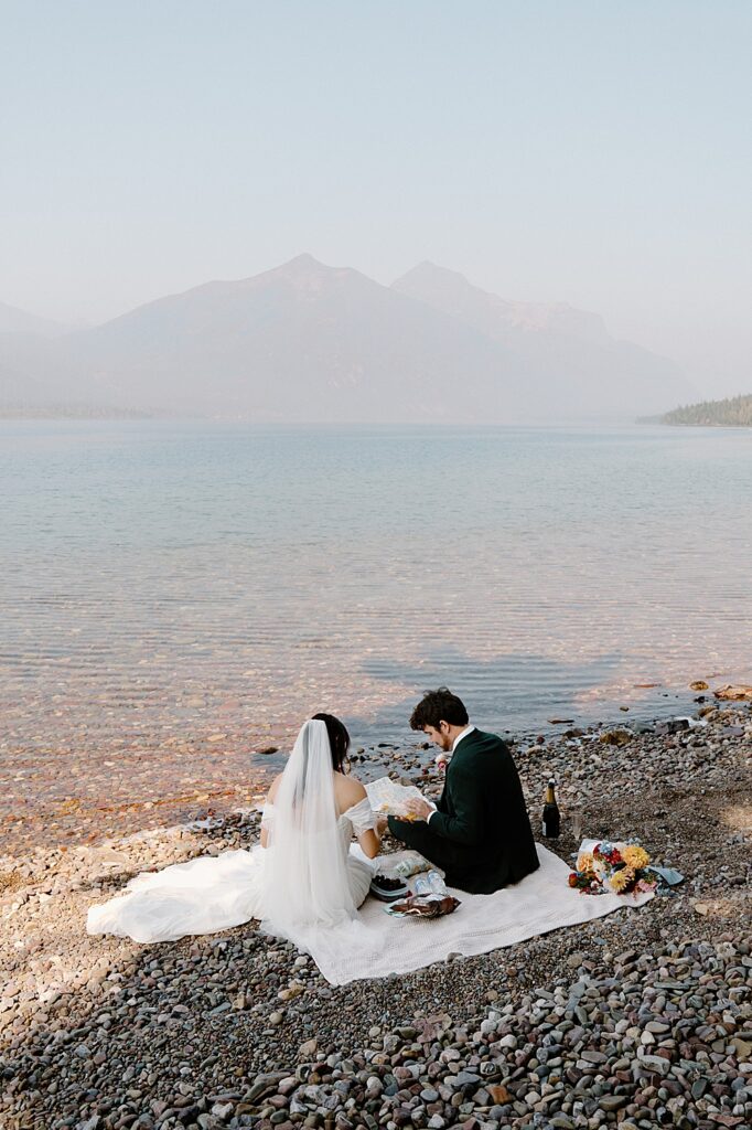 Bride and groom having a small picnic at Lake McDonald