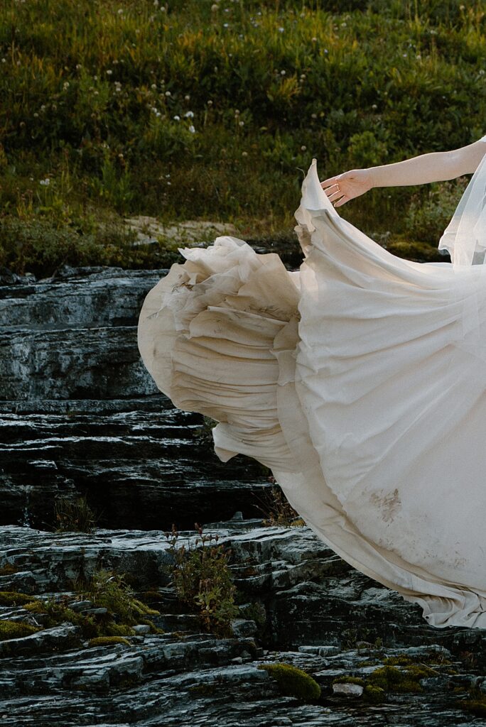 Bride swooshing her dirty dress train