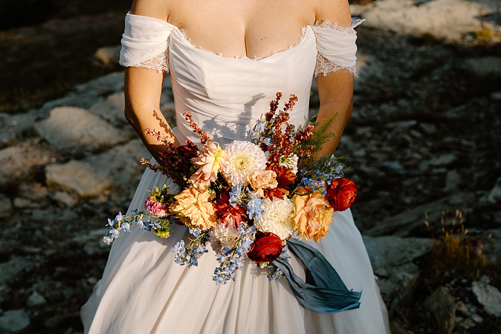 Glacier Park bride holding a colorful, summer bridal bouquet