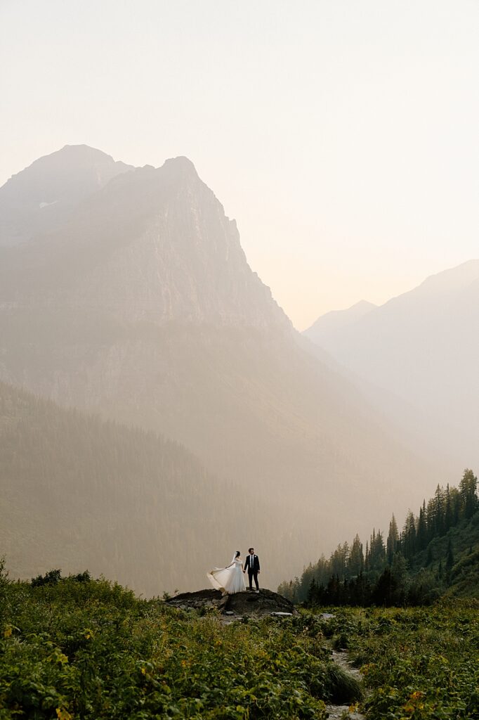 Big Bend elopement portrait of a bride and groom standing on a rock at sunset