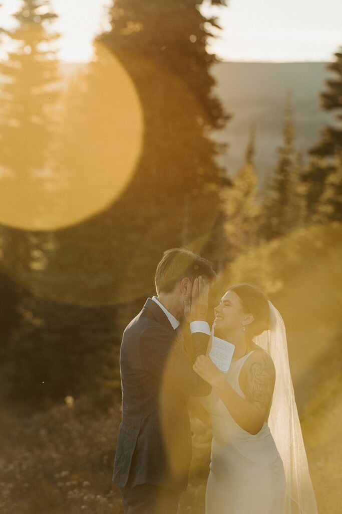 Golden hour photo of bride and groom smiling after saying private vows at their Mt Rainier elopement.