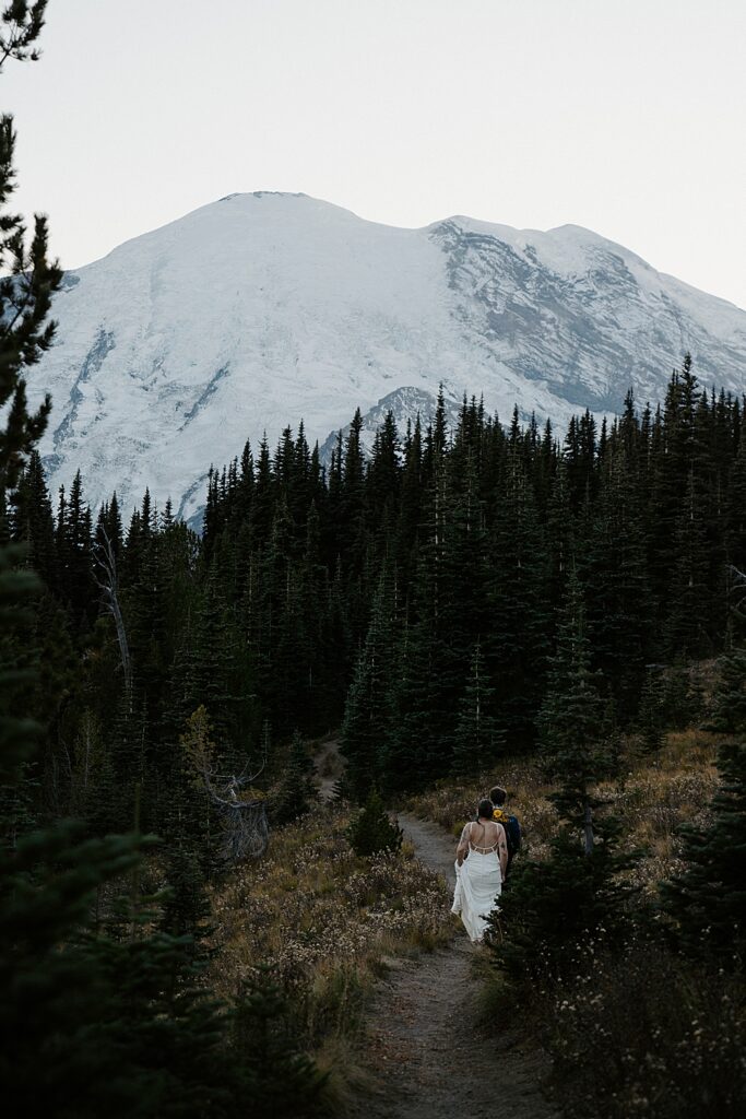 Bride and groom hiking on a trail in Mount Rainier after the sun has gone down.