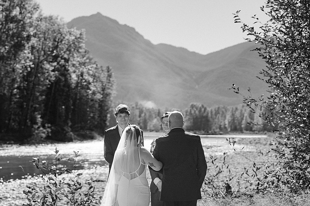 Black & white of father of the bride walking the bride to her groom.