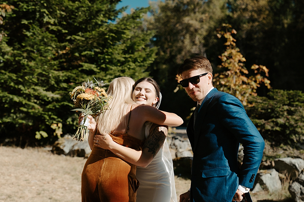 Bride hugging the groom's mom after their wedding ceremony.