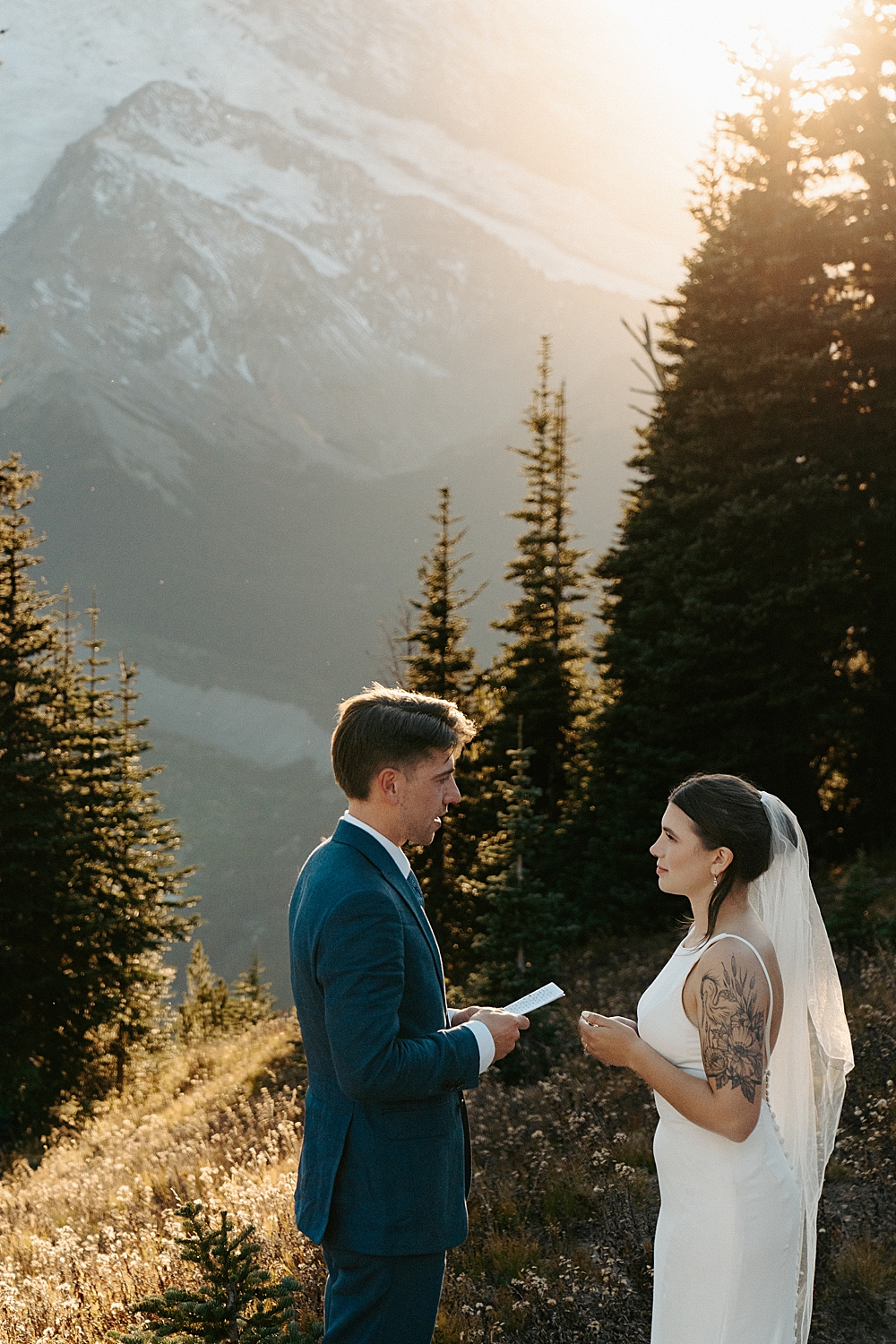 Bride and groom saying vows in Mount Rainier at sunset captured by washington wedding photographer.