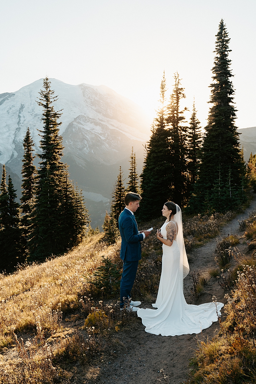Bride and groom saying vows for their Mount Rainier elopement at sunset.