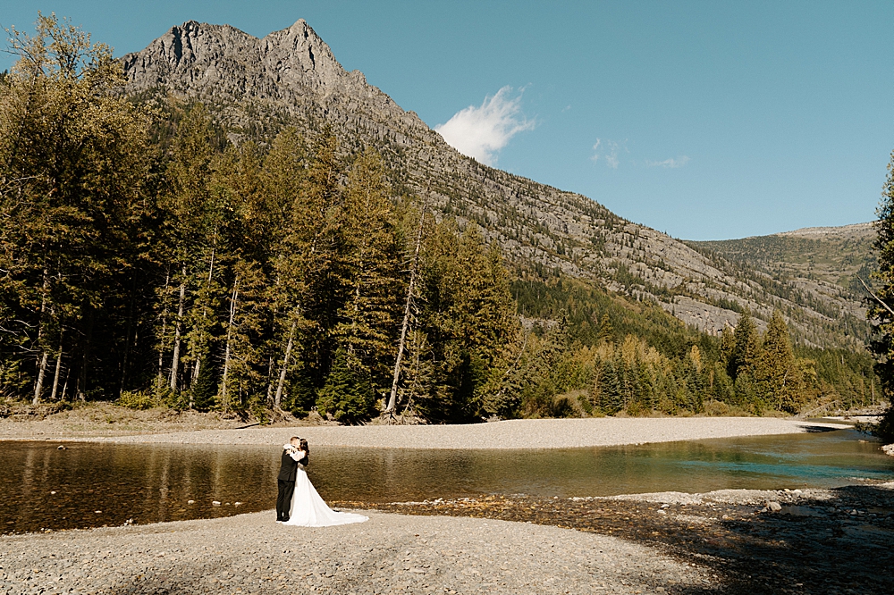 Bride and groom hugging after their first look at Avalanche Creek Picnic Area
