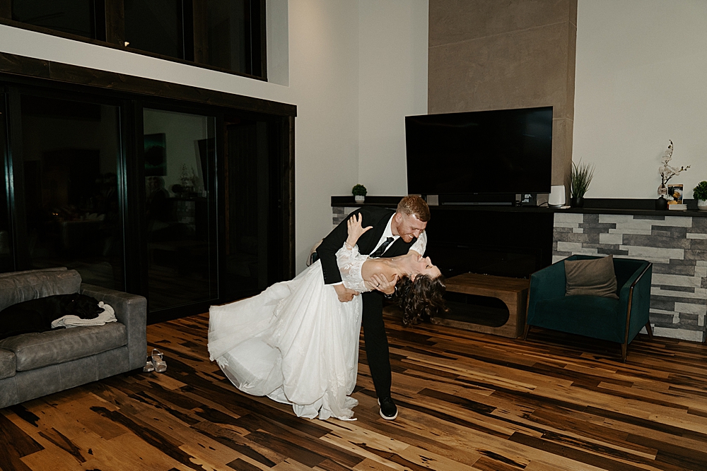 Groom dipping his bride for their first dance at a private rental in Whitefish for their Glacier wedding.